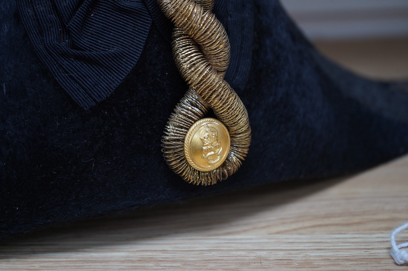 A Naval Lieutenant's bi-corn hat, in its tin case, with applied plaque for D. Donavon R.N. Condition - fair, with general surface rust to the case.